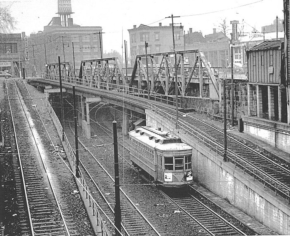 Looking outbound from the Norfolk Street station, the line turns north under a historically problematic bridge carrying traffic over Central Avenue. 
Photo and description from John Crowley
