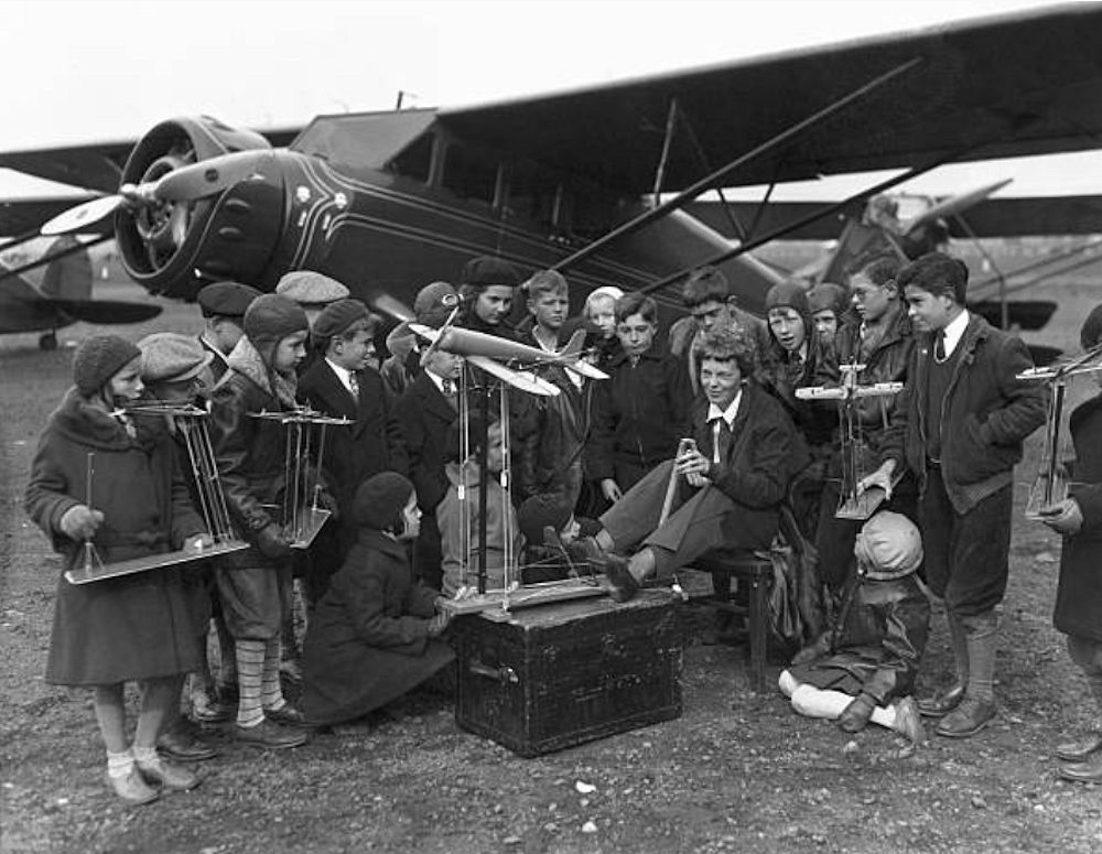Flying Class for Fledglings
Amelia Earhart noted woman pilot is seen here instructing a group of potential 'Eagles' of school years in the mysteries of flying. The transatlantic flight heroine is demonstrating the alluring science with a miniature model plane, that has all the regulation plane controls and gimmicks despite its toy proportions. It happened at the Newark N.J. airport.

Photo from Bettmann
